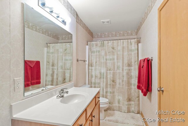 full bathroom with a shower with curtain, vanity, toilet, visible vents, and tile patterned flooring