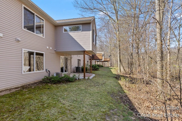 view of yard with central AC unit and a patio area