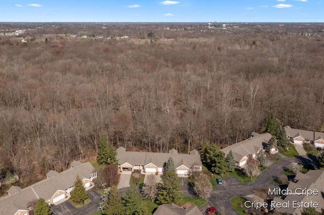 aerial view featuring a residential view and a wooded view