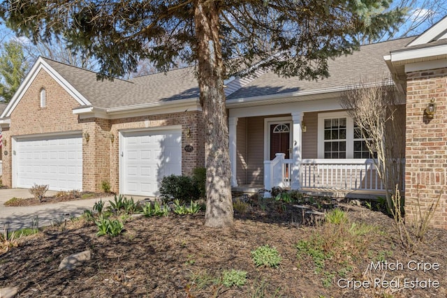 view of front of house featuring brick siding, a porch, and driveway