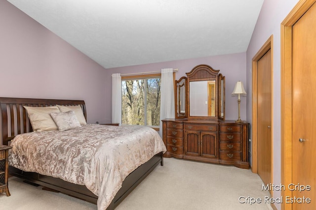 carpeted bedroom with vaulted ceiling