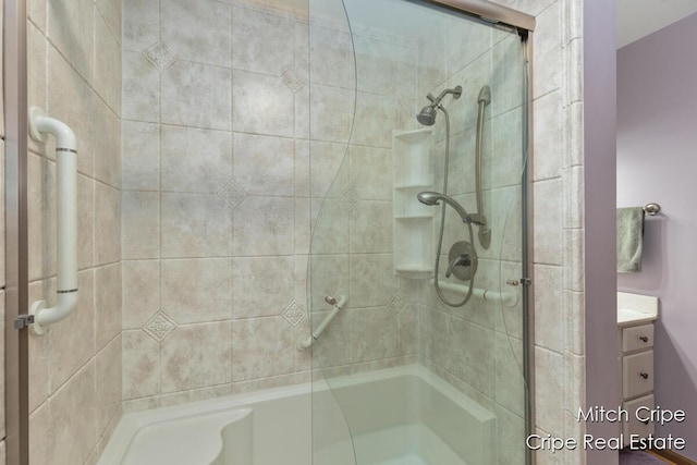 full bathroom with vanity and tiled shower