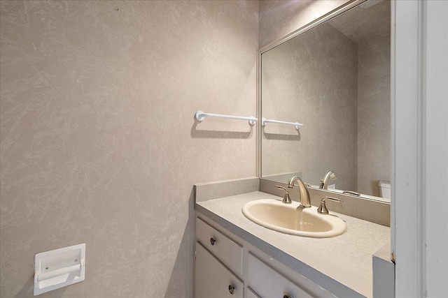 half bath featuring toilet and vanity