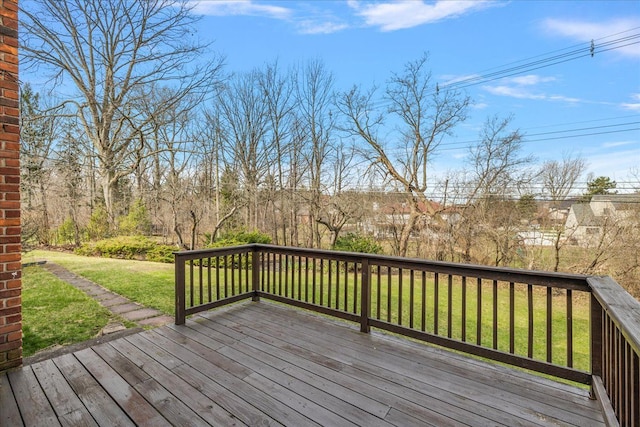 wooden terrace with a lawn