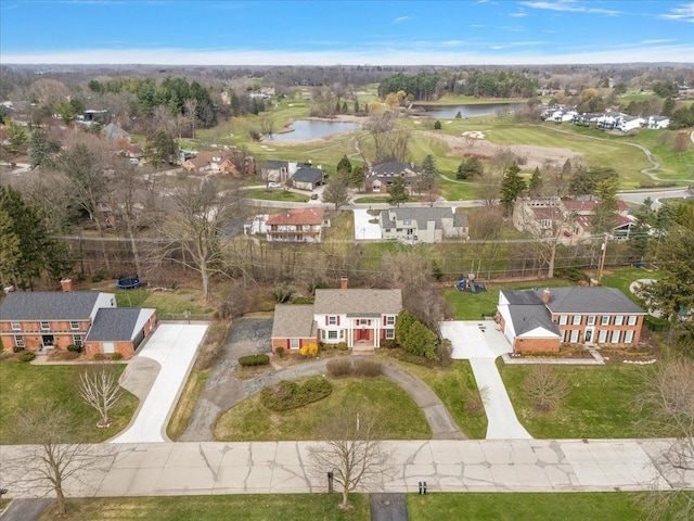 birds eye view of property featuring a water view, a residential view, and view of golf course