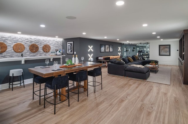 dining area with recessed lighting, baseboards, and light wood-type flooring