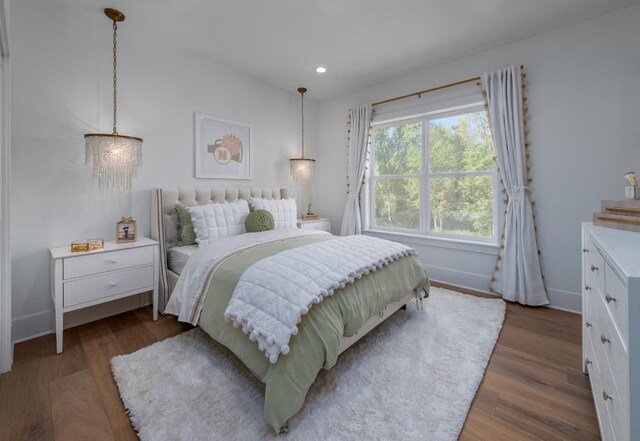 bedroom with baseboards, recessed lighting, and wood finished floors