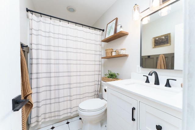 bathroom featuring vanity, a shower with shower curtain, and toilet