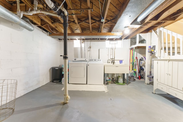 below grade area with a sink and separate washer and dryer