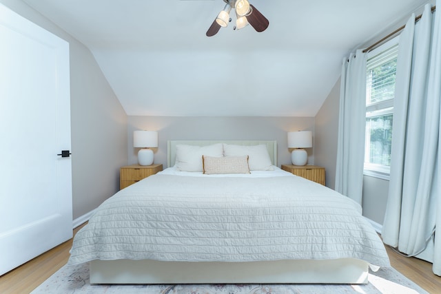 bedroom featuring light wood finished floors, ceiling fan, and vaulted ceiling