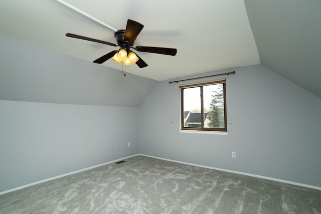 additional living space featuring lofted ceiling, carpet flooring, visible vents, ceiling fan, and baseboards