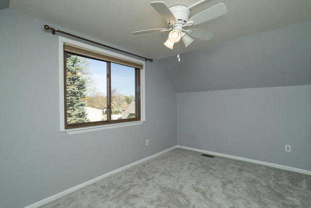 bonus room with carpet flooring, a ceiling fan, visible vents, vaulted ceiling, and baseboards