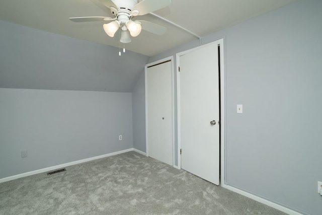 additional living space with a ceiling fan, visible vents, vaulted ceiling, carpet, and baseboards