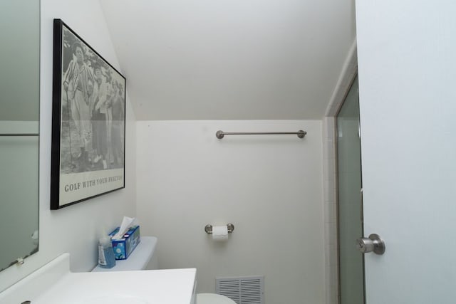bathroom with lofted ceiling, visible vents, toilet, and vanity