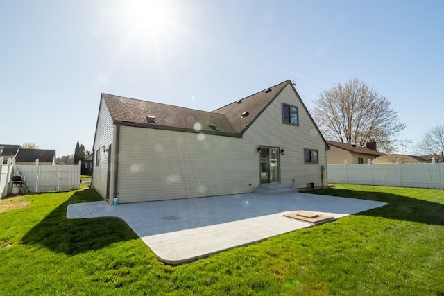 back of house with fence, roof with shingles, a lawn, and a patio