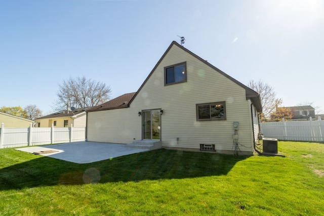 rear view of house featuring a patio, fence, central AC unit, and a yard