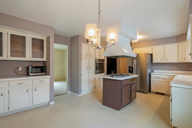 kitchen featuring a sink, stainless steel appliances, light countertops, an inviting chandelier, and a center island with sink