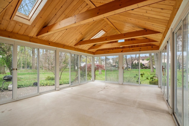 unfurnished sunroom featuring lofted ceiling with skylight and concrete floors
