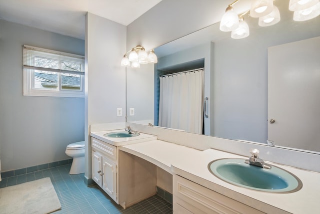 bathroom with tile patterned floors, toilet, double vanity, and a sink