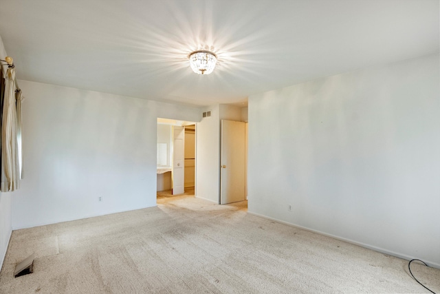 unfurnished room featuring visible vents and light colored carpet