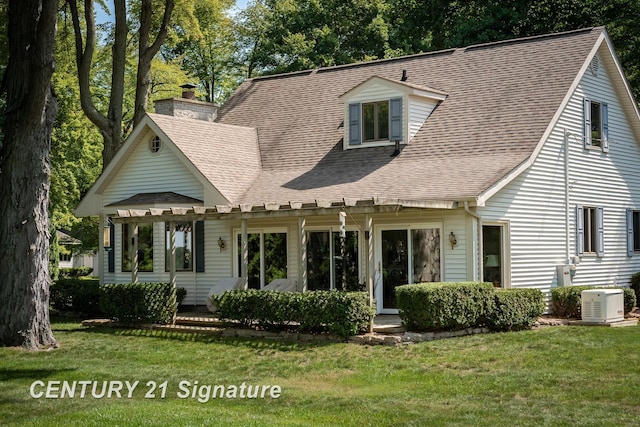 33 Ferro St, Sanford, MI 48657 - back of house with a chimney, a shingled roof, and a lawn