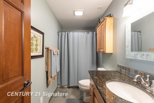 33 Ferro St, Sanford, MI 48657 - bathroom with stone finish flooring, toilet, curtained shower, and vanity