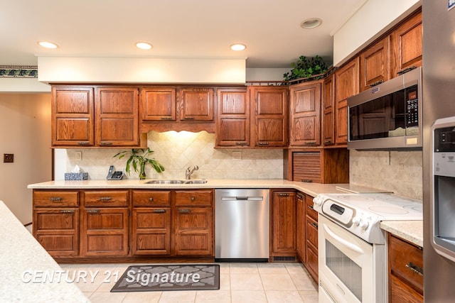 33 Ferro St, Sanford, MI 48657 - kitchen with appliances with stainless steel finishes, brown cabinets, light countertops, and a sink