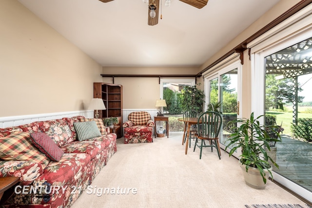 33 Ferro St, Sanford, MI 48657 - living area featuring a wainscoted wall, a ceiling fan, and carpet