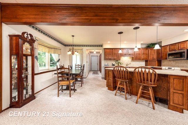 33 Ferro St, Sanford, MI 48657 - dining space featuring a chandelier, baseboards, and light carpet