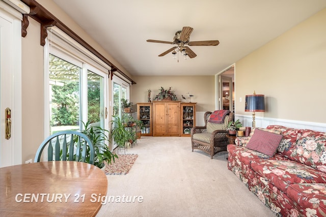 33 Ferro St, Sanford, MI 48657 - living area with ceiling fan, wainscoting, and carpet floors