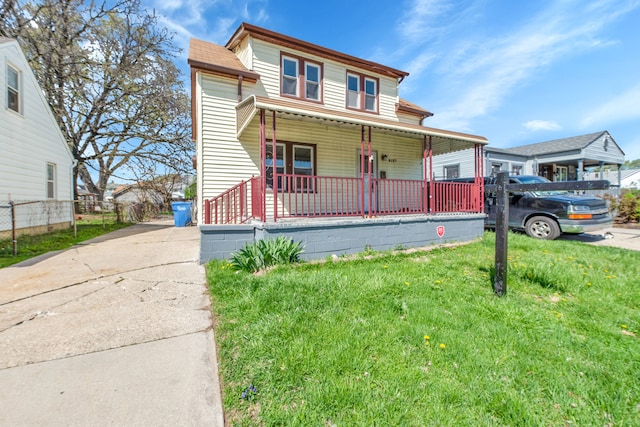 8127 Continental Ave, Warren, MI 48089 - traditional-style house with covered porch, fence, and a front yard
