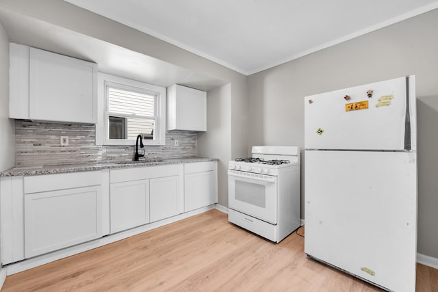 8127 Continental Ave, Warren, MI 48089 - kitchen featuring white cabinetry, tasteful backsplash, light wood-style flooring, a sink, and white appliances