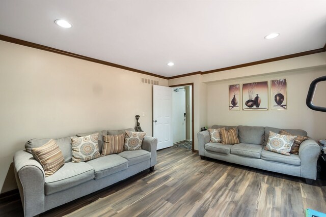 living area with visible vents, recessed lighting, wood finished floors, and ornamental molding