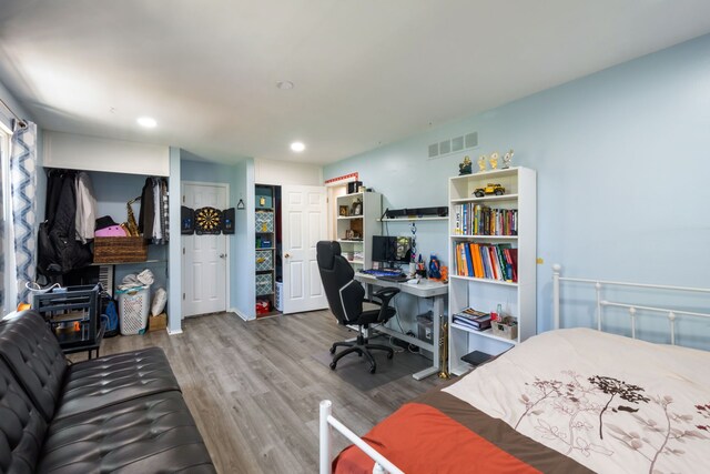 bedroom featuring visible vents, recessed lighting, and wood finished floors