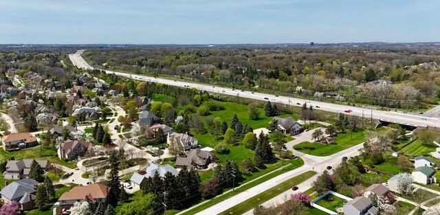 aerial view featuring a view of trees and a residential view