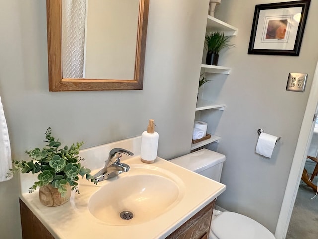 bathroom with toilet and vanity