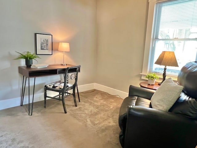 office area with baseboards and light carpet