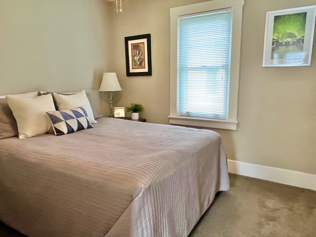 carpeted bedroom featuring baseboards