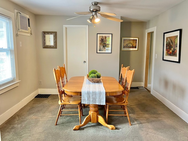 carpeted dining area with baseboards, visible vents, a wall unit AC, and a ceiling fan