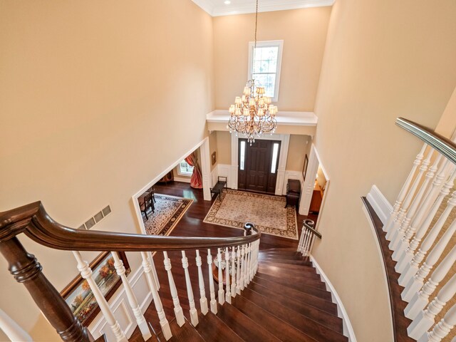 810 Highwood Dr, Bloomfield Hills, MI 48304 - foyer entrance with crown molding, stairway, a chandelier, and dark wood finished floors