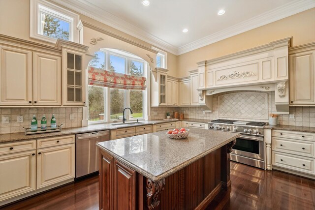 810 Highwood Dr, Bloomfield Hills, MI 48304 - kitchen featuring cream cabinets, a sink, appliances with stainless steel finishes, and a healthy amount of sunlight