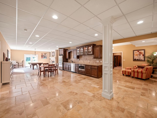 810 Highwood Dr, Bloomfield Hills, MI 48304 - kitchen with stone tile floors, glass insert cabinets, appliances with stainless steel finishes, a drop ceiling, and ornate columns