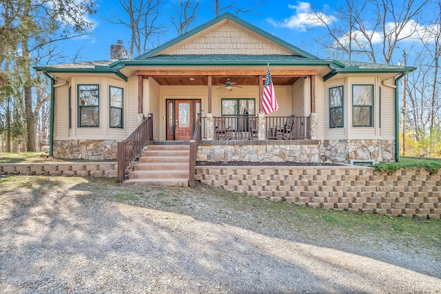 3553 Alpine Ct, Hillsdale, MI 49242 - view of front facade with stone siding, a chimney, a shingled roof, covered porch, and a ceiling fan