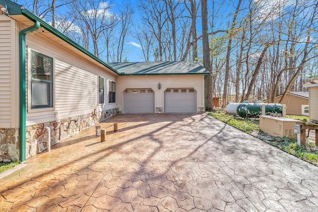 3553 Alpine Ct, Hillsdale, MI 49242 - view of property exterior with a garage and aphalt driveway