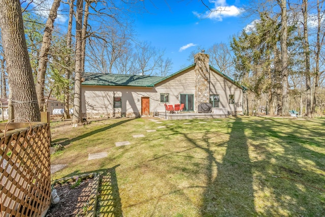 3553 Alpine Ct, Hillsdale, MI 49242 - back of property featuring a lawn and a chimney