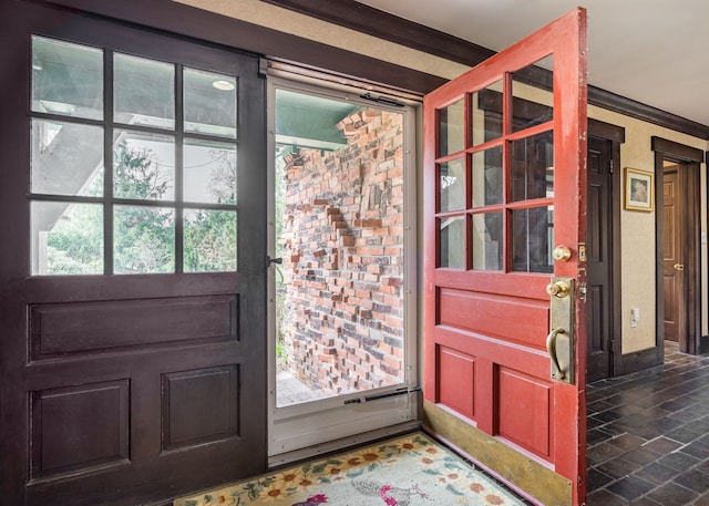 doorway featuring crown molding and stone finish floor