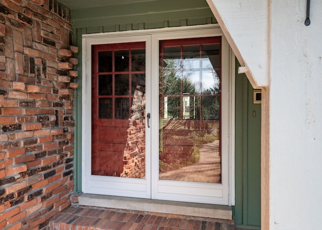 entrance to property featuring brick siding