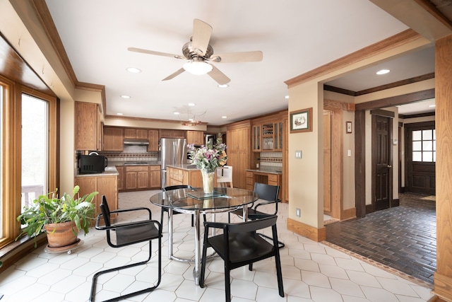 dining area with baseboards, ornamental molding, recessed lighting, and ceiling fan