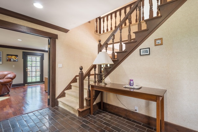 staircase with baseboards, ornamental molding, and recessed lighting