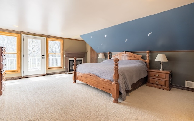 carpeted bedroom featuring access to outside, baseboards, and visible vents